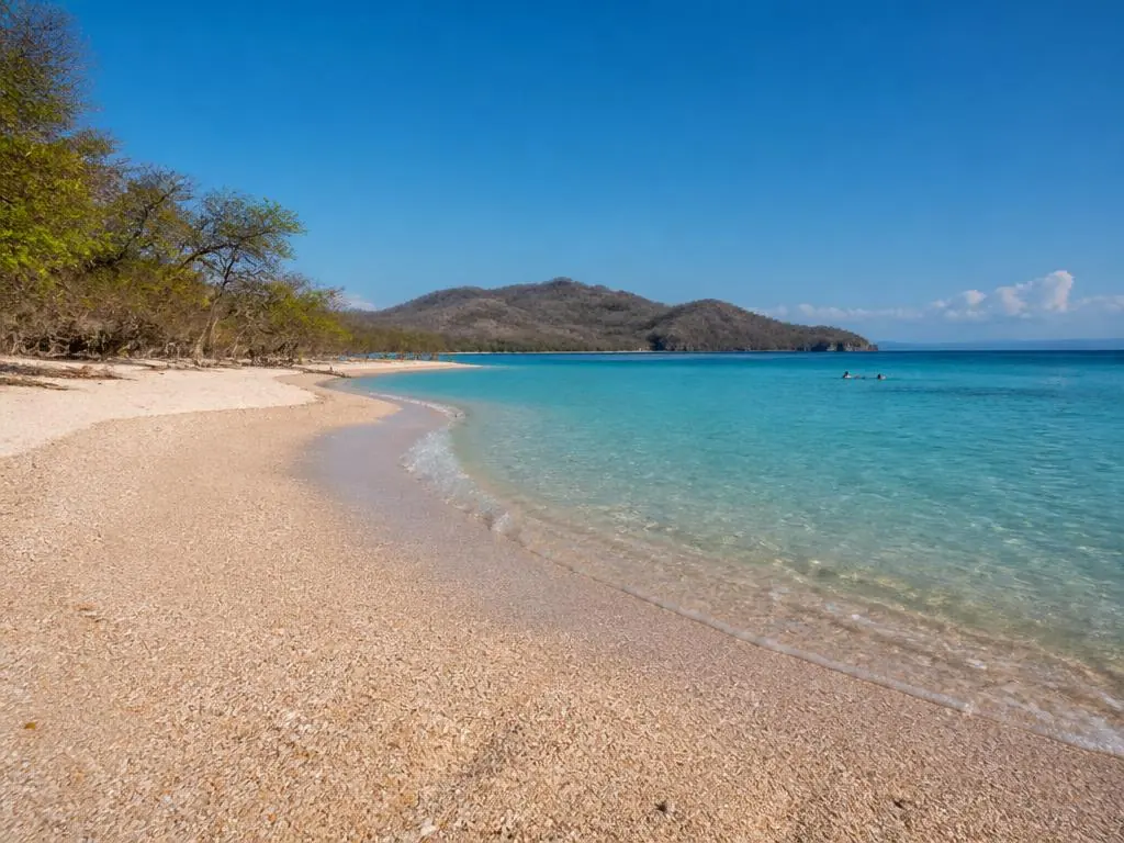 Crushed shell beach and clear water at Playa Conchal