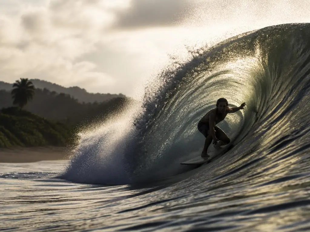 A surfer inside a powerful barrel at Playa Hermosa